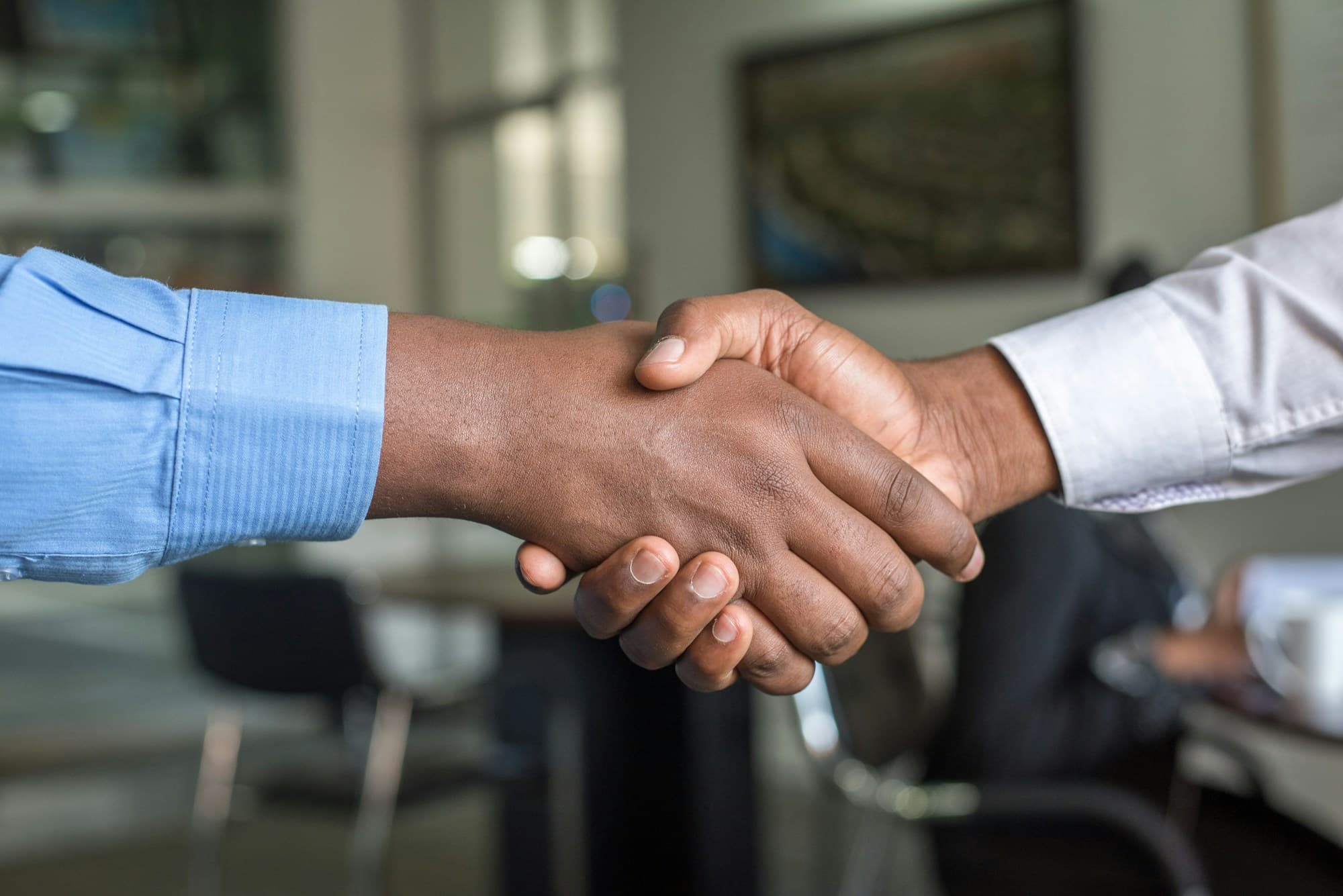 Franchise partnership handshake for EV charging business